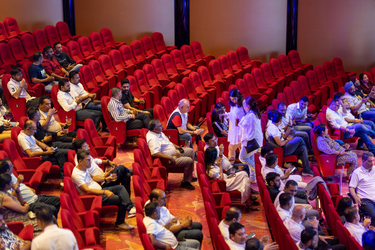 Travel partners gathered in the ship's theater for the on-board event