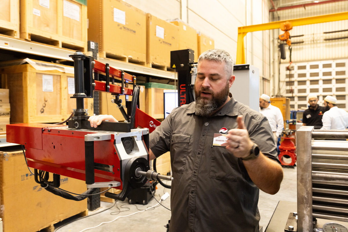 Visiting technicians demonstrating equipment at the workshop