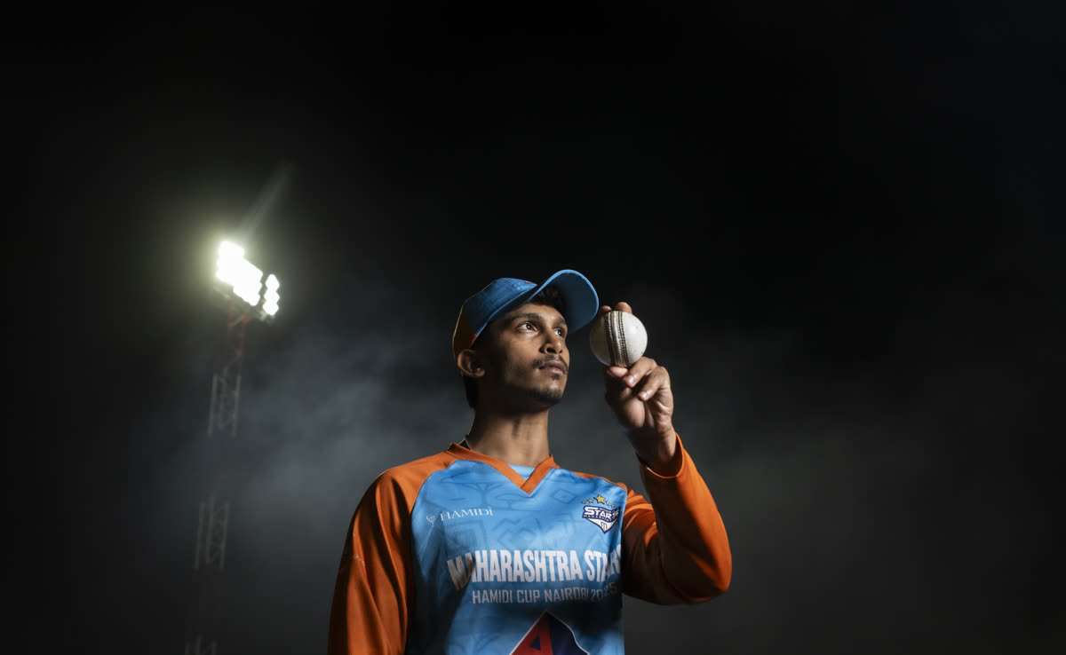 Sports event portrait, cricket player under floodlights